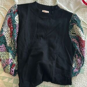 Black knit sweater with animal print puff sleeves